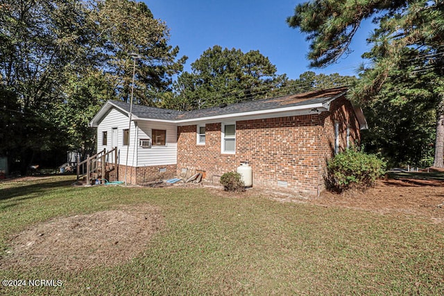 exterior space with cooling unit and a lawn