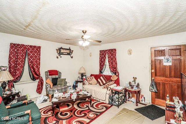 carpeted living room featuring a textured ceiling and ceiling fan