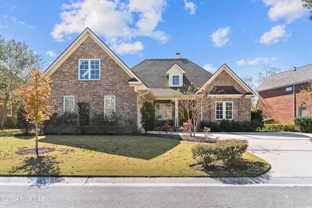 view of property featuring a front lawn