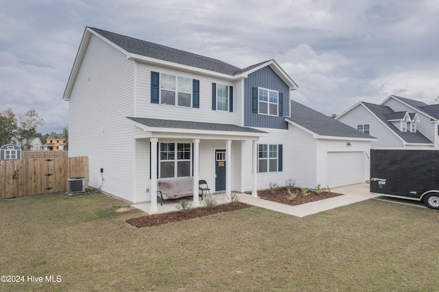 front facade featuring a garage, central AC, and a front lawn