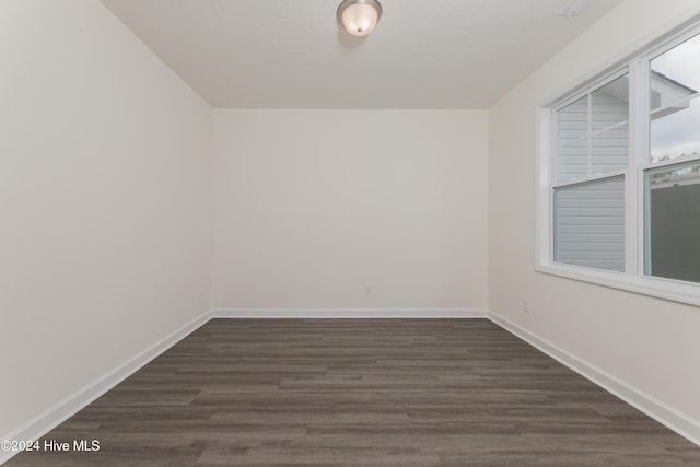 unfurnished room featuring dark hardwood / wood-style flooring