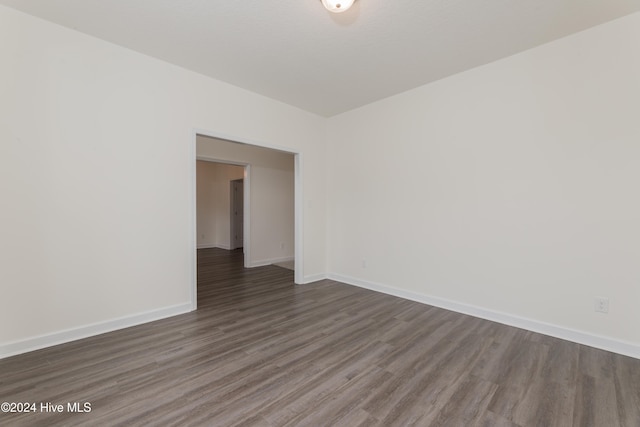 unfurnished room featuring dark hardwood / wood-style flooring