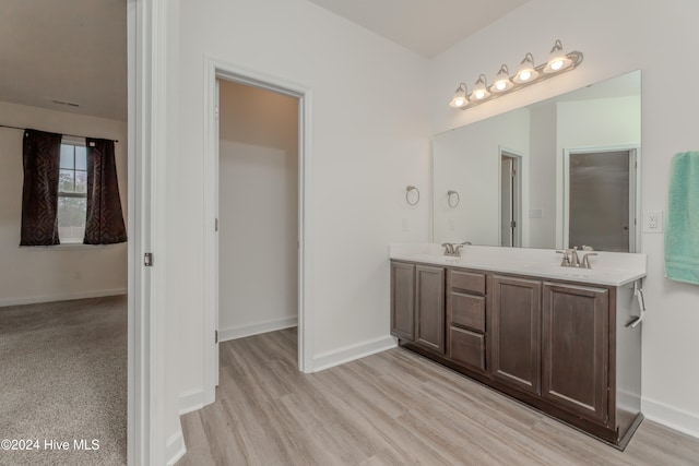 bathroom with hardwood / wood-style flooring and vanity