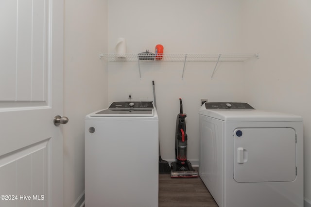 laundry room featuring washing machine and dryer and dark hardwood / wood-style floors