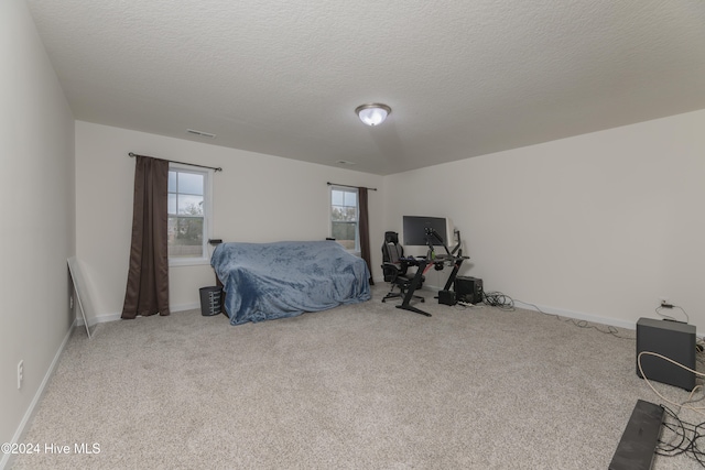 bedroom featuring a textured ceiling and carpet floors