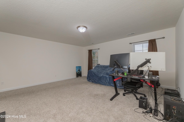 bedroom with a textured ceiling and light carpet