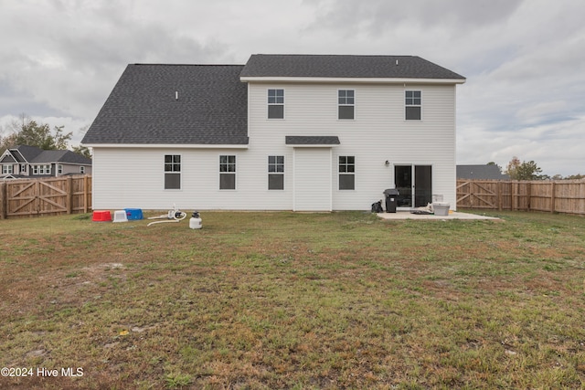 back of house featuring a yard and a patio area