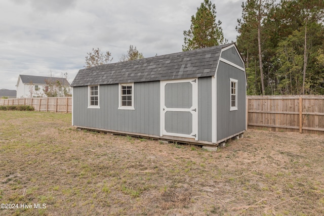 view of outdoor structure featuring a lawn