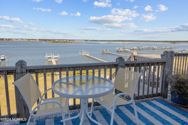 wooden terrace with a water view and a dock