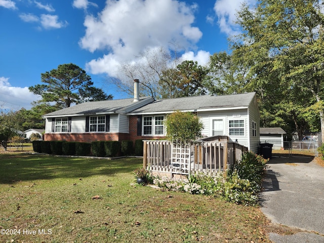 rear view of property with a wooden deck and a yard