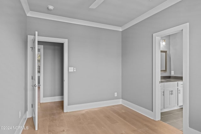 unfurnished bedroom featuring ornamental molding, ceiling fan, light hardwood / wood-style floors, and ensuite bathroom