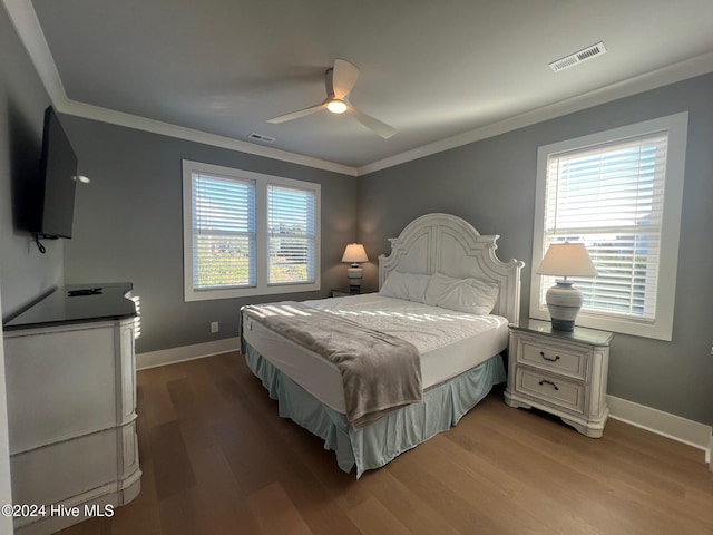 bedroom with hardwood / wood-style flooring, ceiling fan, and crown molding