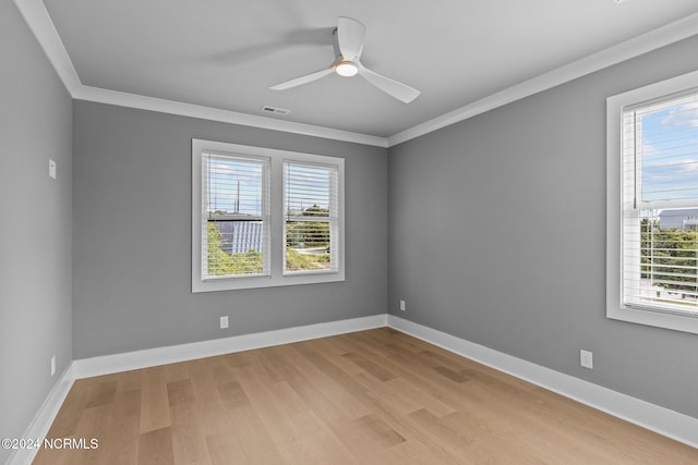 spare room featuring light hardwood / wood-style flooring, ceiling fan, and crown molding