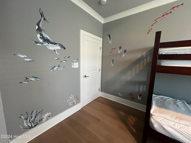 bedroom with hardwood / wood-style flooring and crown molding