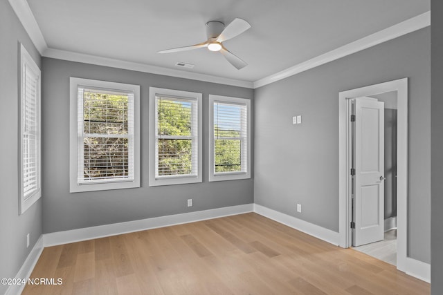 spare room with light hardwood / wood-style flooring, ceiling fan, and crown molding