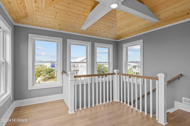 unfurnished sunroom featuring vaulted ceiling and wooden ceiling