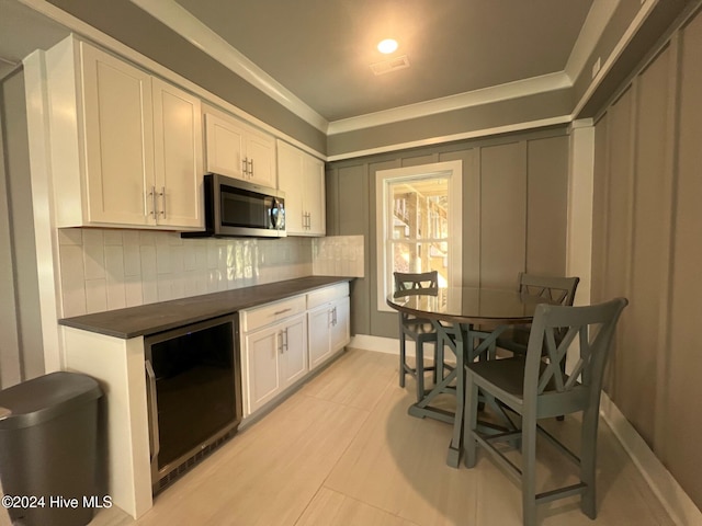 kitchen featuring white cabinets, light tile patterned floors, backsplash, and wine cooler