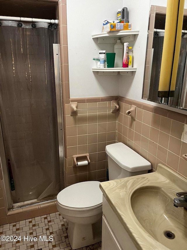 bathroom featuring vanity, toilet, tile walls, and curtained shower