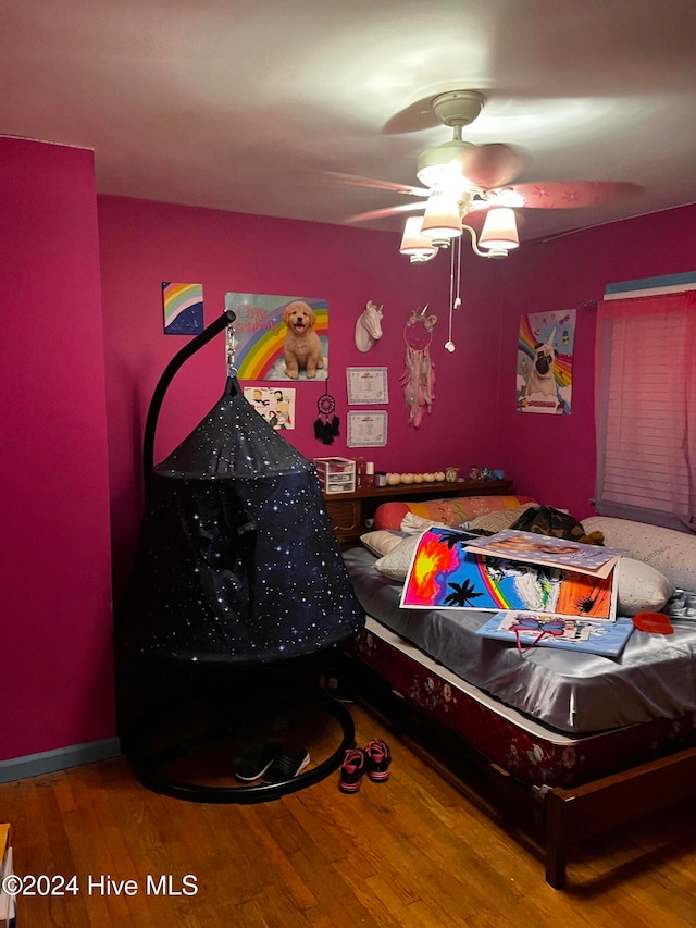 bedroom featuring ceiling fan and hardwood / wood-style floors