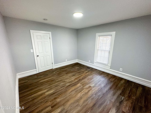 empty room featuring dark hardwood / wood-style flooring