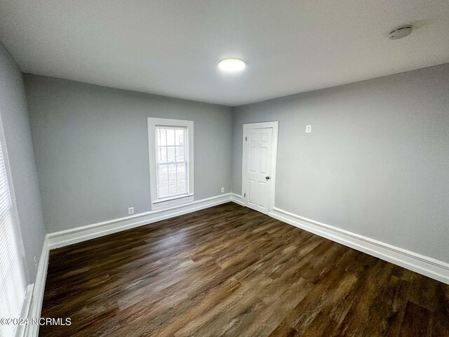 spare room featuring dark hardwood / wood-style floors