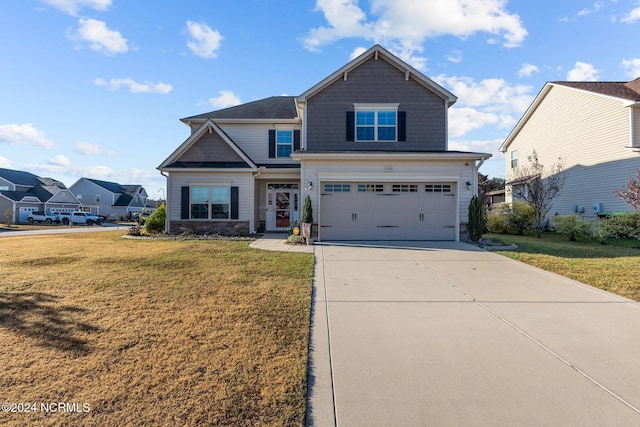 craftsman-style house with a front yard and a garage