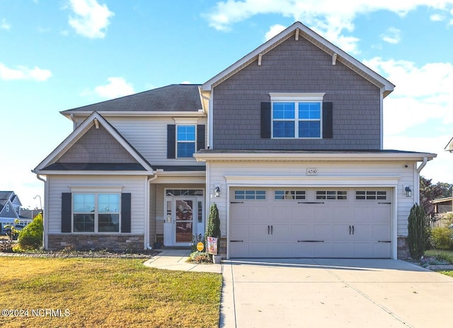 craftsman-style house with a front yard and a garage