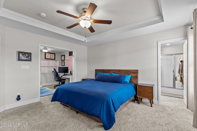 carpeted bedroom featuring crown molding, ceiling fan, and a raised ceiling