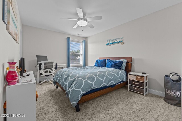 bedroom featuring a closet, ceiling fan, and light colored carpet