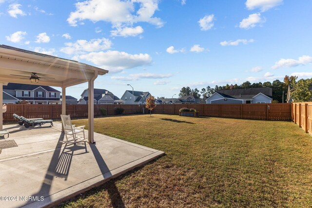 back of property featuring a patio, a lawn, and solar panels