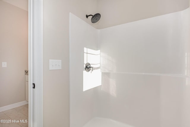 bathroom with tile patterned flooring and a shower