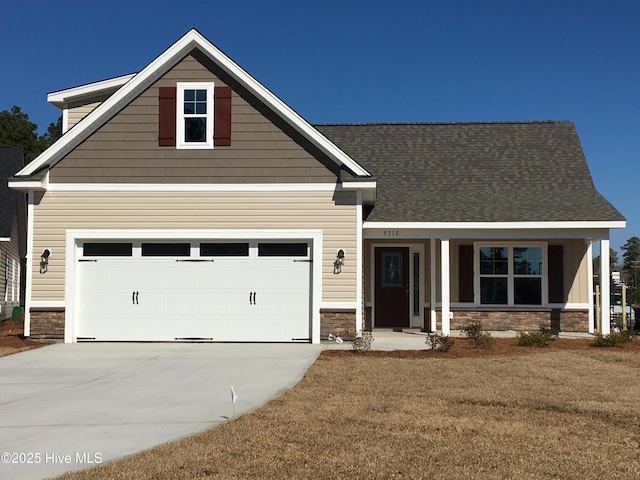 craftsman-style home featuring a garage, a front yard, and a porch