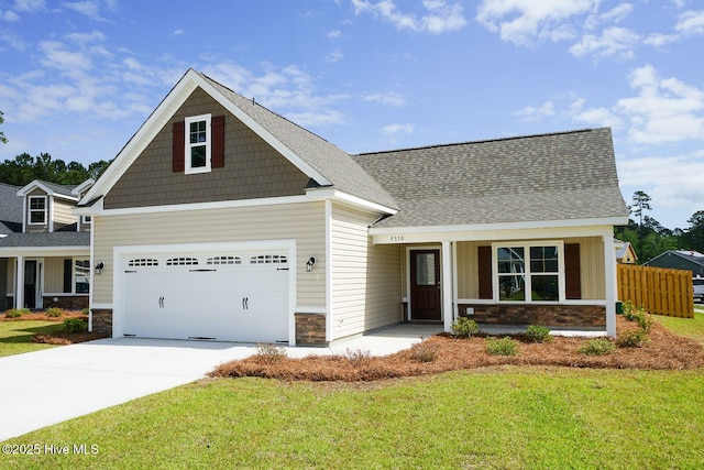 craftsman inspired home featuring a front lawn, driveway, stone siding, fence, and roof with shingles
