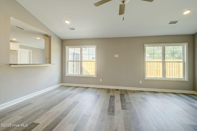 unfurnished room with baseboards, visible vents, and ceiling fan