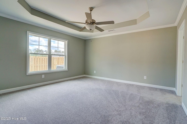 unfurnished room featuring crown molding, carpet flooring, visible vents, and a raised ceiling