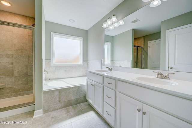 bathroom with a shower stall, visible vents, a garden tub, and a sink