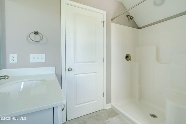 full bathroom featuring tile patterned flooring, vanity, and a shower