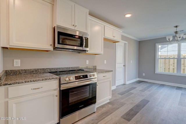 kitchen featuring a chandelier, appliances with stainless steel finishes, light wood finished floors, white cabinetry, and ornamental molding