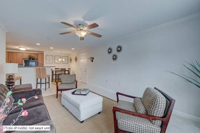 carpeted living room with ceiling fan and ornamental molding