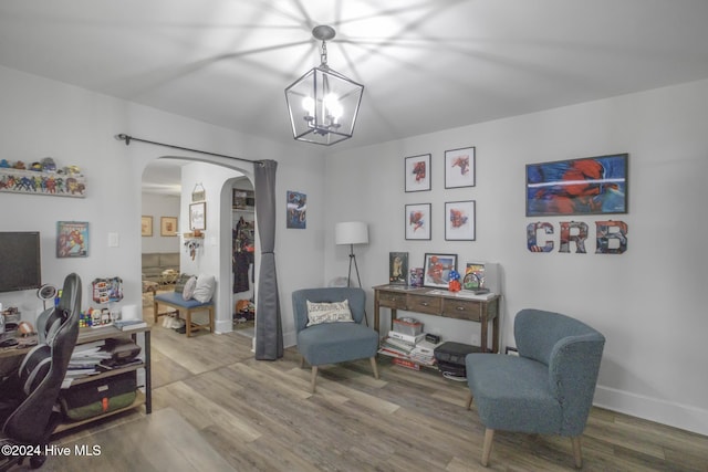 sitting room featuring hardwood / wood-style floors and a notable chandelier