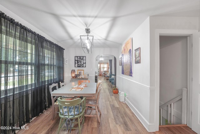 dining room with hardwood / wood-style flooring and a chandelier