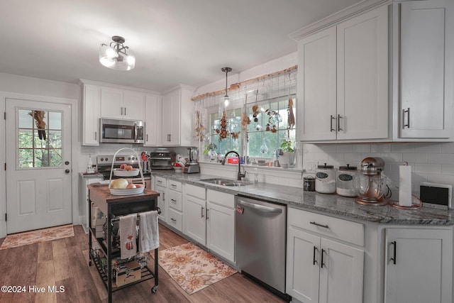 kitchen with white cabinets, appliances with stainless steel finishes, dark wood-type flooring, and sink