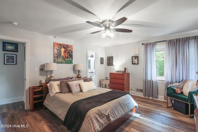 bedroom with dark hardwood / wood-style flooring and ceiling fan