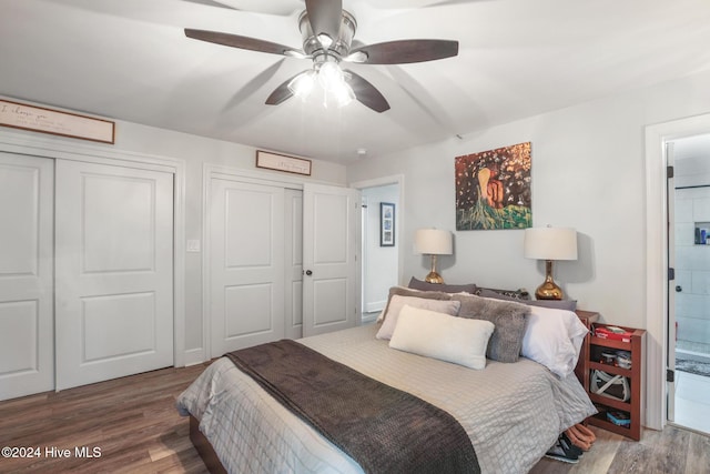 bedroom featuring ensuite bath, wood-type flooring, ceiling fan, and a closet