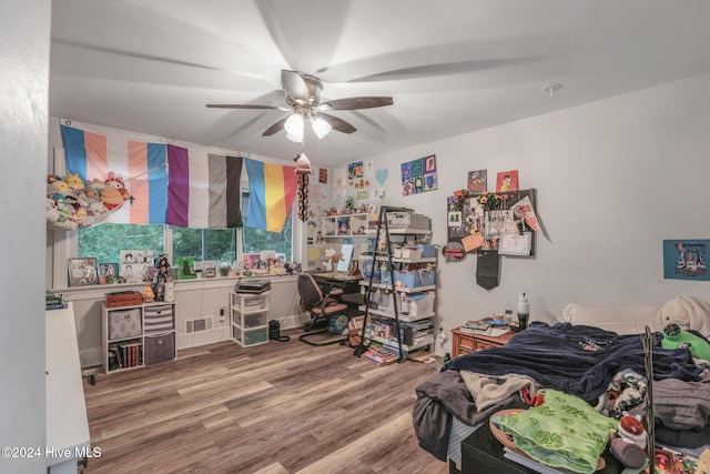 bedroom with hardwood / wood-style floors and ceiling fan