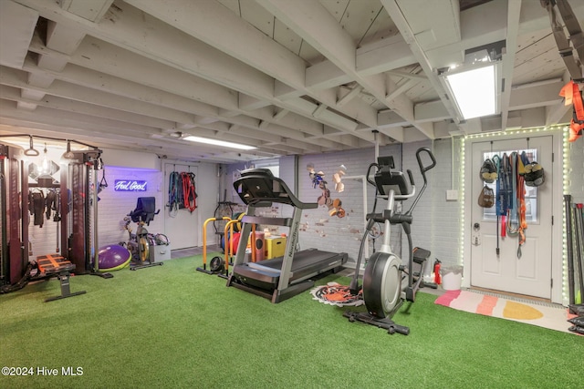 interior space with brick wall and carpet flooring