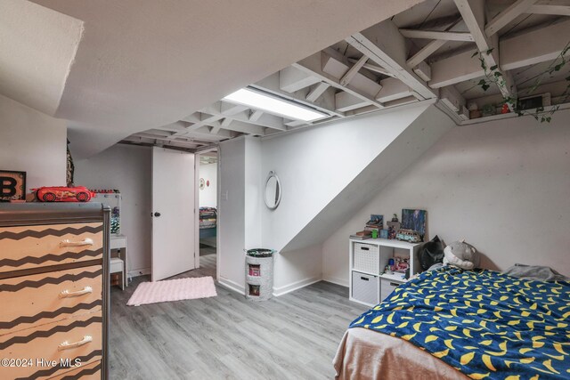 bedroom with hardwood / wood-style flooring