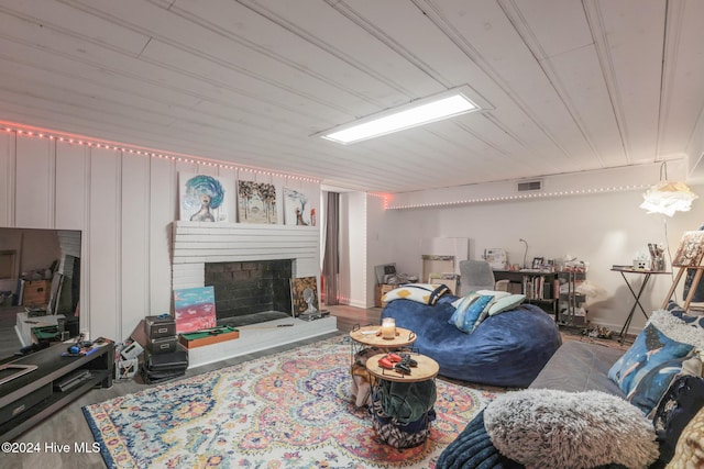 living room featuring a brick fireplace