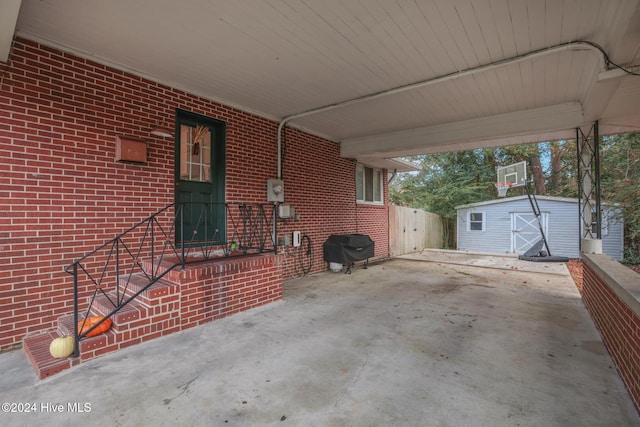 view of patio / terrace featuring a shed and area for grilling