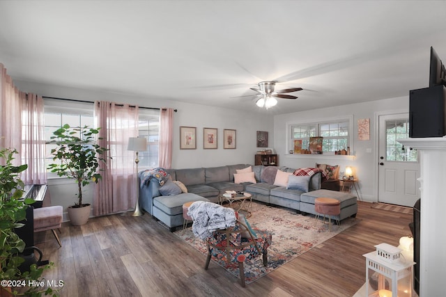 living room featuring hardwood / wood-style floors, ceiling fan, and plenty of natural light